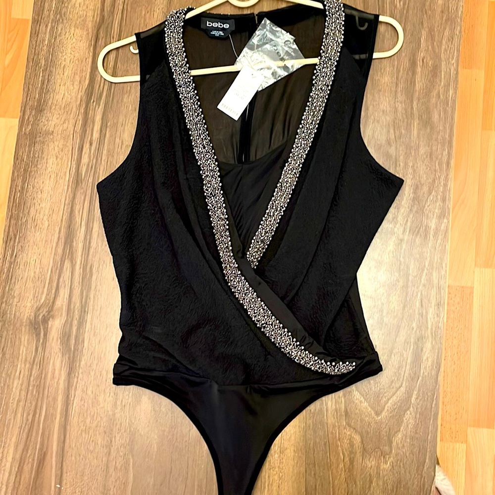BEBE bodysuit with original tags . Size M - Black - Perfect condition.